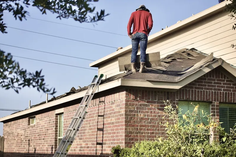 Professional roofer working on a residential roof in Lithia